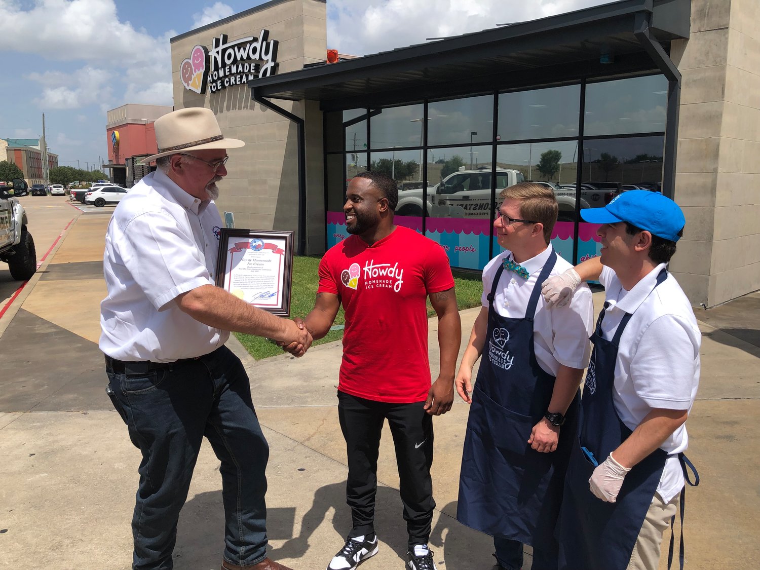 Harris County Pet. 4 Commissioner Jack Cagle, left, awards a proclamation to Howdy Homemade Ice Cream shop owner Roderick Batson, Austin Hanson and Andrew Heap. The store refers to its employees as “heroes.”